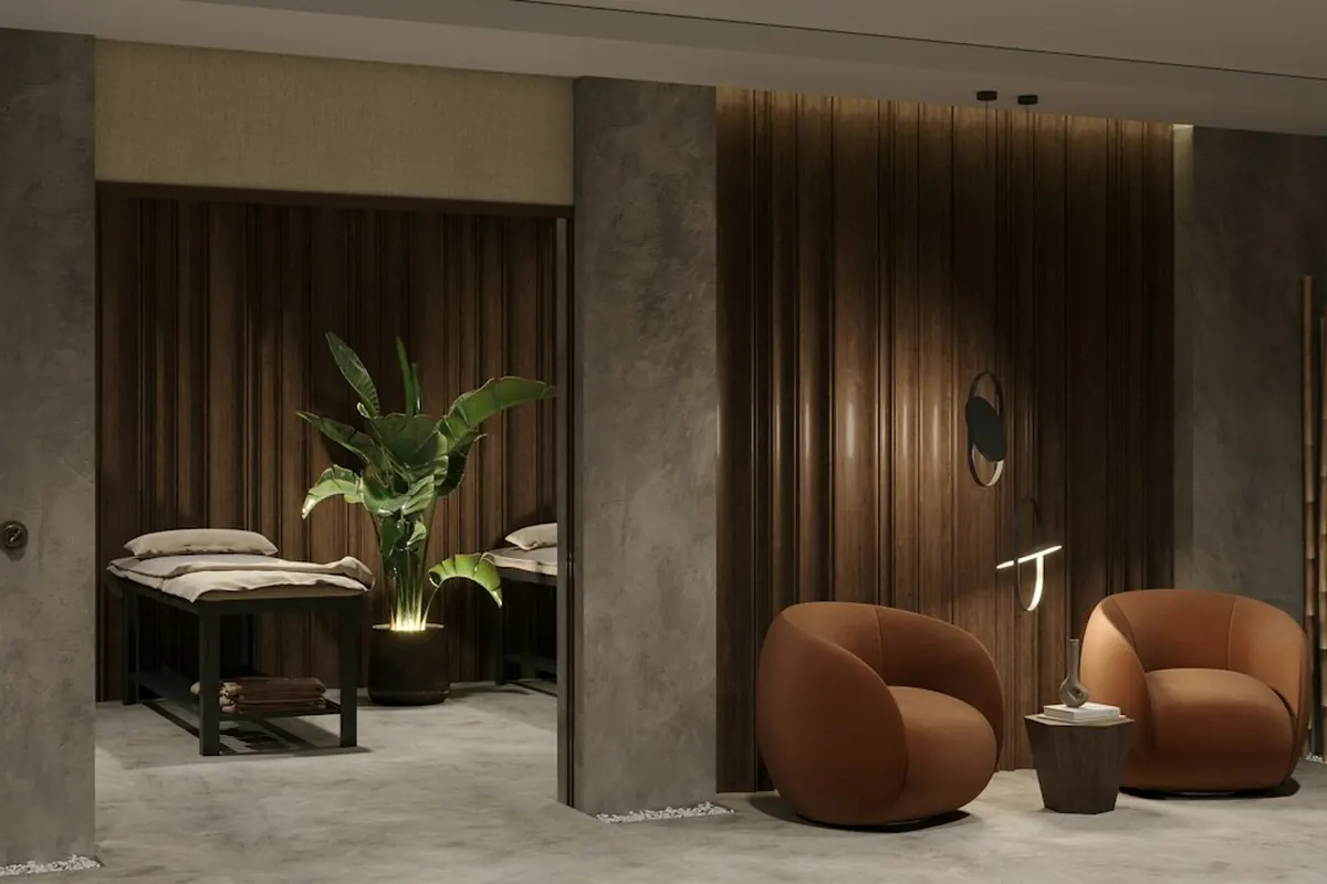 A spa interior with warm wood panels, lounge chairs and a treatment bed